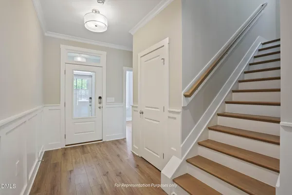 a view of a hallway with wooden floor and staircase