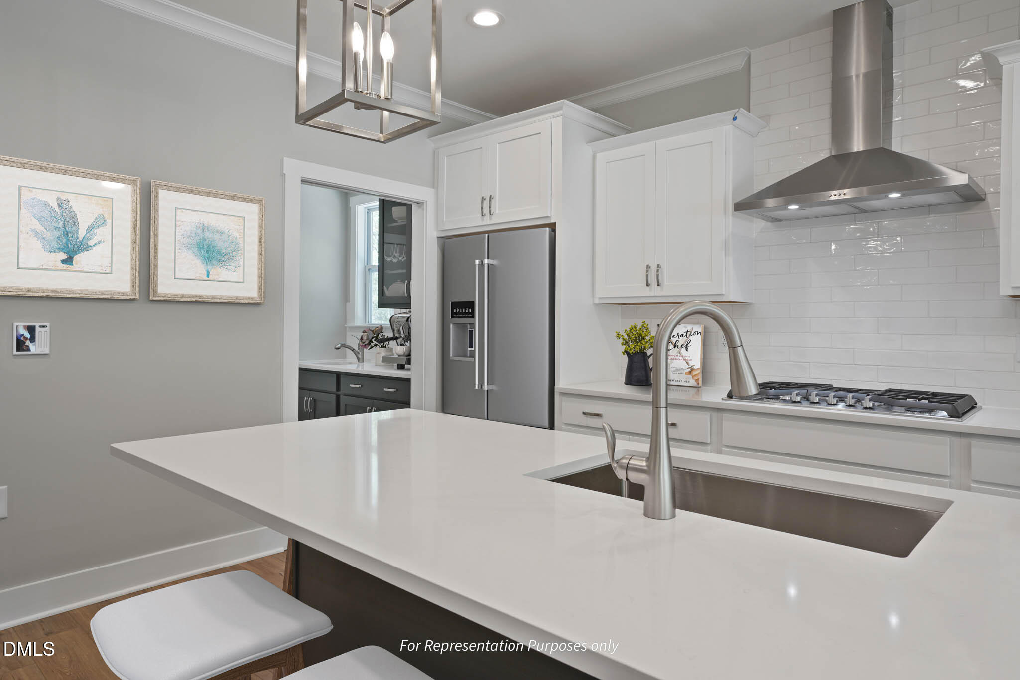 8924 Brook Trout Lane Willow Spring, NC 27592 - Photo 6 of 16 a kitchen with stainless steel appliances a table chairs and cabinets