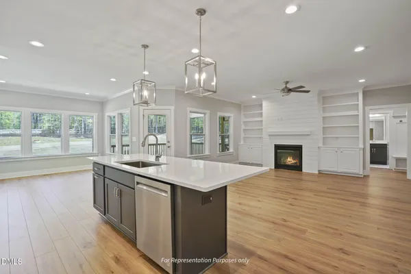 a kitchen with stainless steel appliances granite countertop a kitchen island a stove and a wooden floors