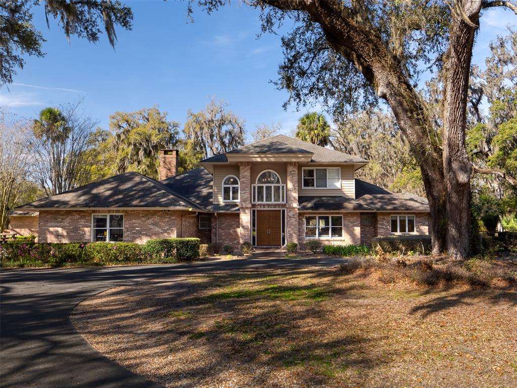 4986 Southwest 7th Avenue Road Ocala, FL 34471 - Photo 1 of 39 a front view of a building with a garden