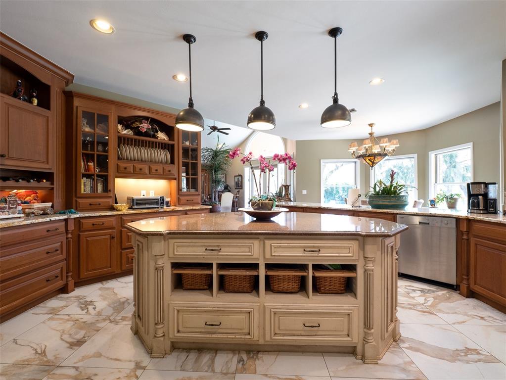 4986 Southwest 7th Avenue Road Ocala, FL 34471 - Photo 11 of 39 a kitchen with stainless steel appliances granite countertop a stove a sink and a wooden floors