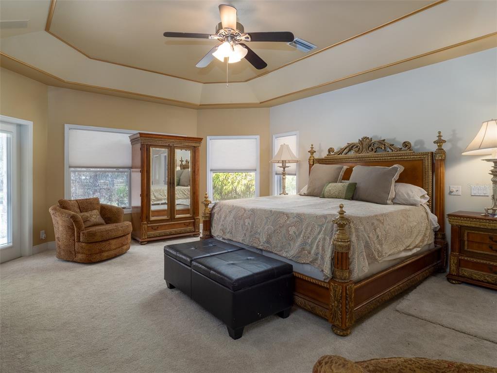 4986 Southwest 7th Avenue Road Ocala, FL 34471 - Photo 13 of 39 a bedroom with a bed couch and window