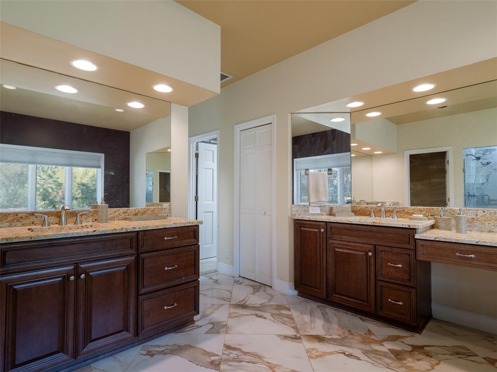 4986 Southwest 7th Avenue Road Ocala, FL 34471 - Photo 15 of 39 a bathroom with a granite countertop sink and a large mirror