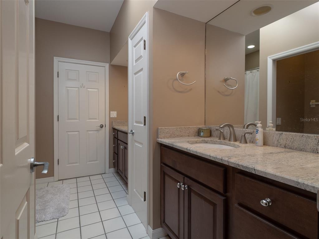 4986 Southwest 7th Avenue Road Ocala, FL 34471 - Photo 20 of 39 a bathroom with a granite countertop sink and a mirror