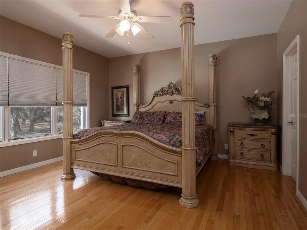 4986 Southwest 7th Avenue Road Ocala, FL 34471 - Photo 21 of 39 a bedroom with a bed and wooden floor