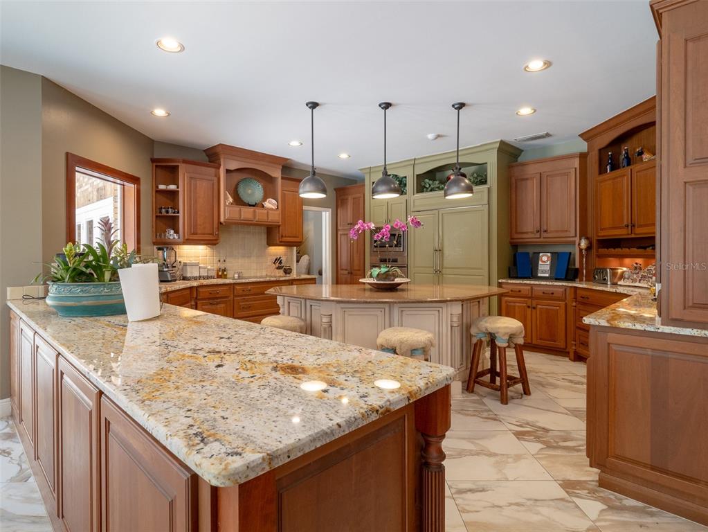4986 Southwest 7th Avenue Road Ocala, FL 34471 - Photo 9 of 39 a kitchen with granite countertop kitchen island stainless steel appliances a sink and a living room view