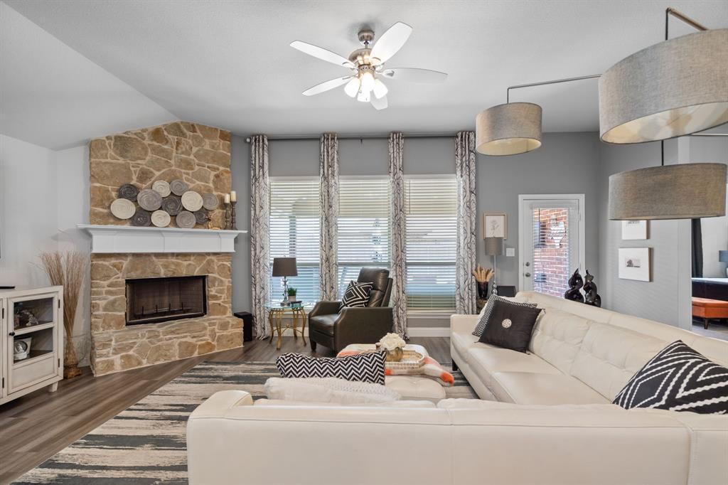 3724 Ranchers Ridge Krum, TX 76249 - Photo 13 of 32 Cozy fireplace with a stone surround serves as the rooms focal point!