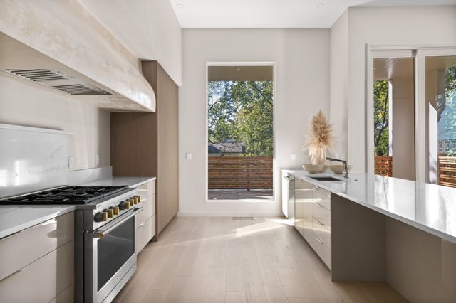 a kitchen with granite countertop a stove and a sink
