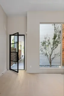 a view of a livingroom with a fireplace and window