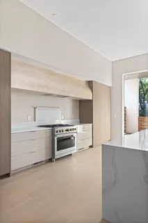 a large white kitchen with a large window