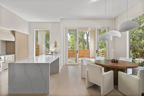 a kitchen with kitchen island stainless steel appliances a sink and a refrigerator