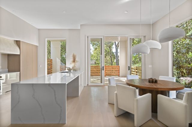 a kitchen with kitchen island stainless steel appliances a sink and a refrigerator