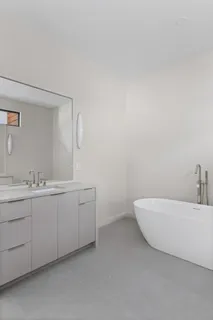 a view of an empty room and kitchen