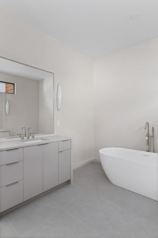 a view of an empty room and kitchen