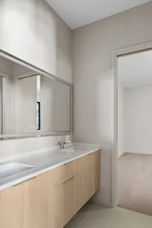 a view of a kitchen with a sink and a refrigerator