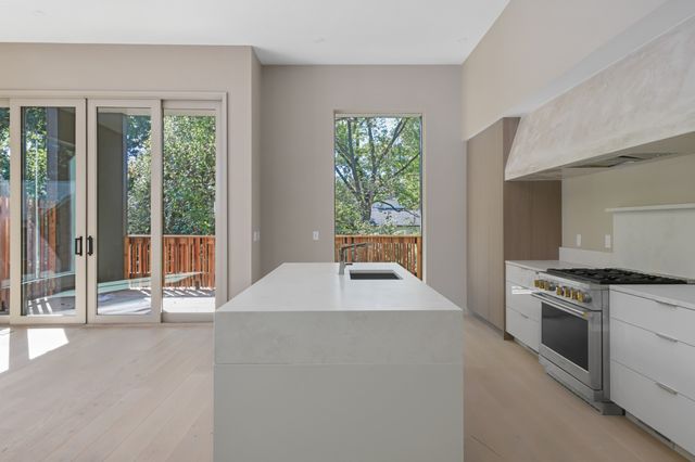 a kitchen with a stove and a sink