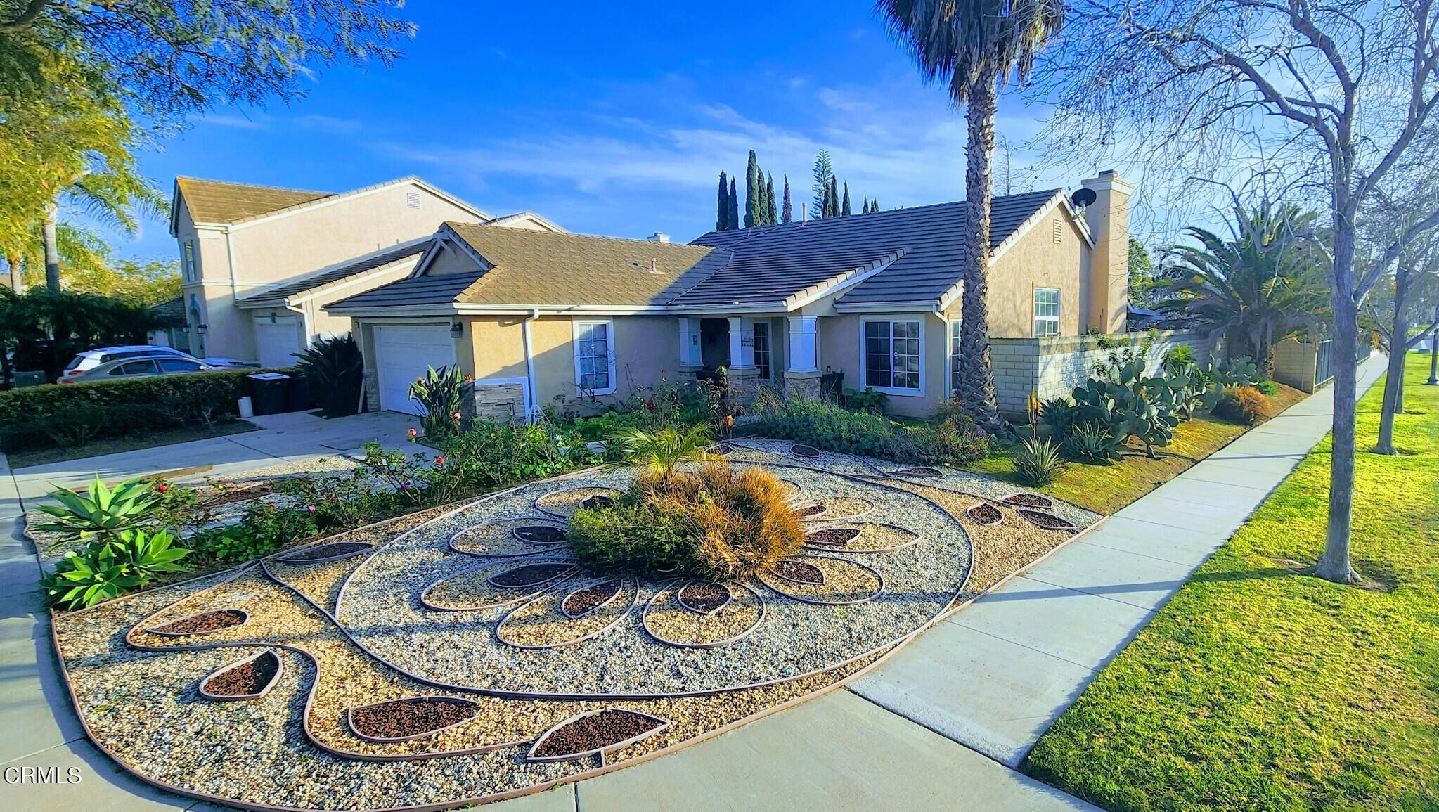 a view of a house with swimming pool and garden