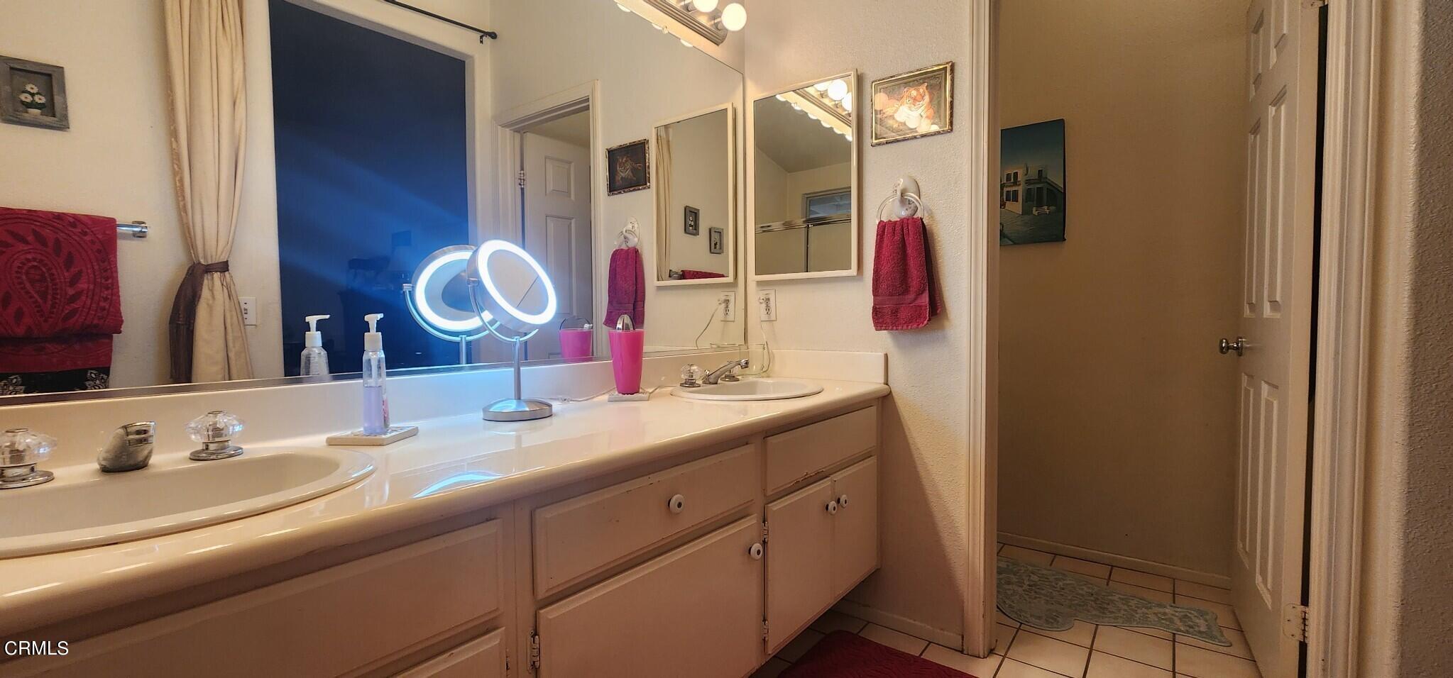 1500 Gabriella Drive Oxnard, CA 93030 - Photo 14 of 23 a bathroom with a granite countertop sink and a mirror
