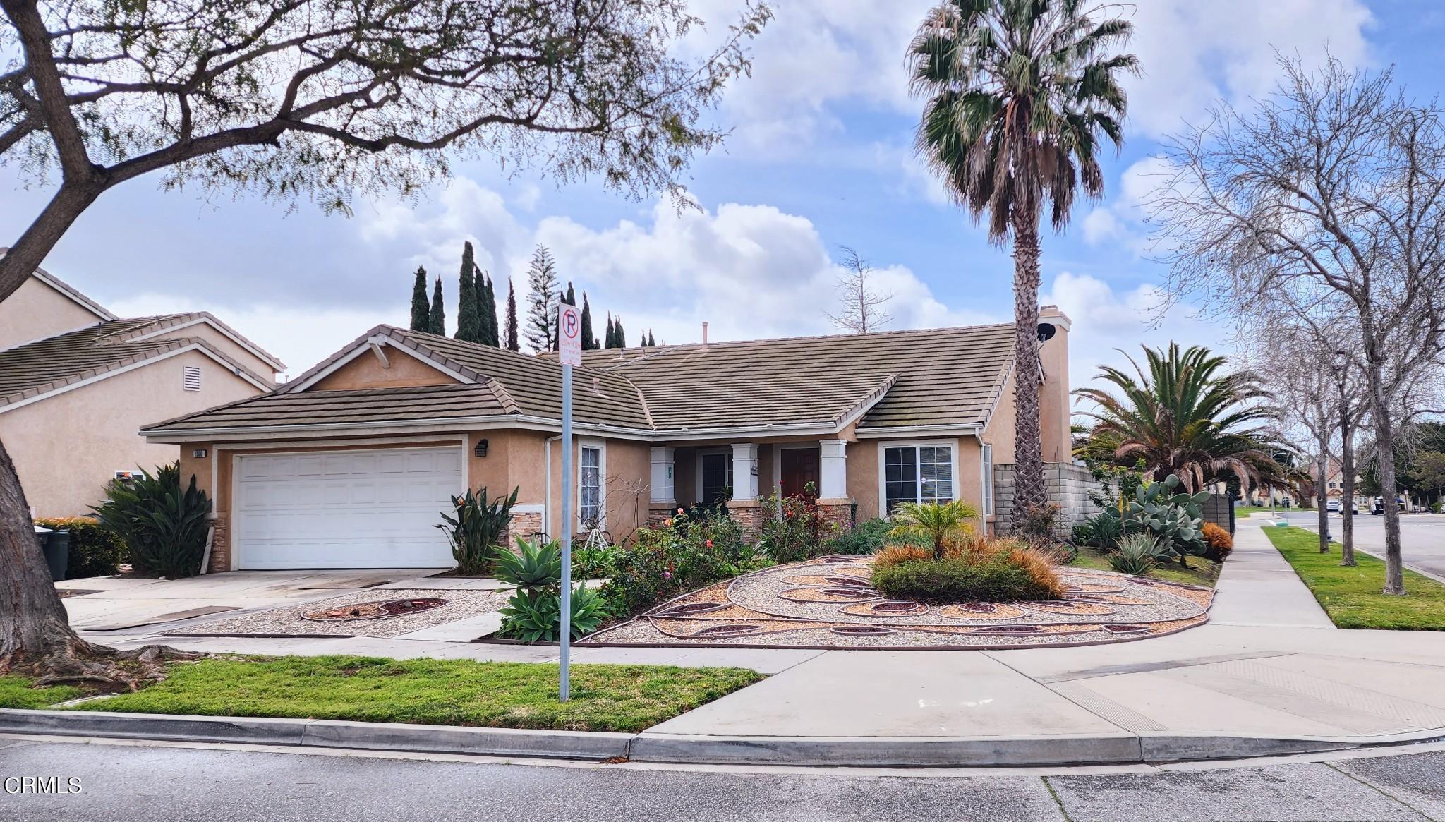 1500 Gabriella Drive Oxnard, CA 93030 - Photo 2 of 23 a front view of a house with garage and plants
