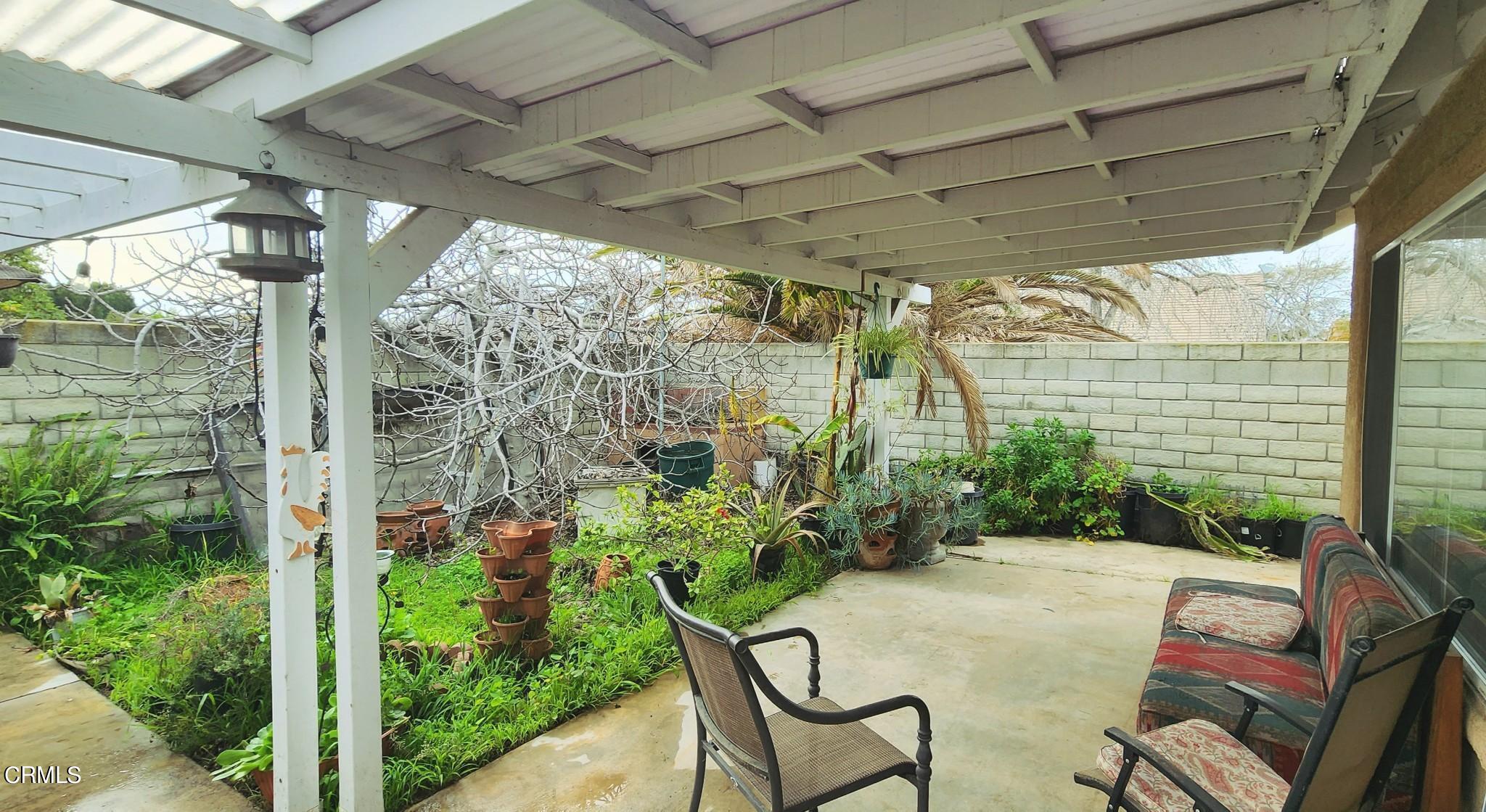 1500 Gabriella Drive Oxnard, CA 93030 - Photo 21 of 23 a backyard of a house with table and chairs potted plants