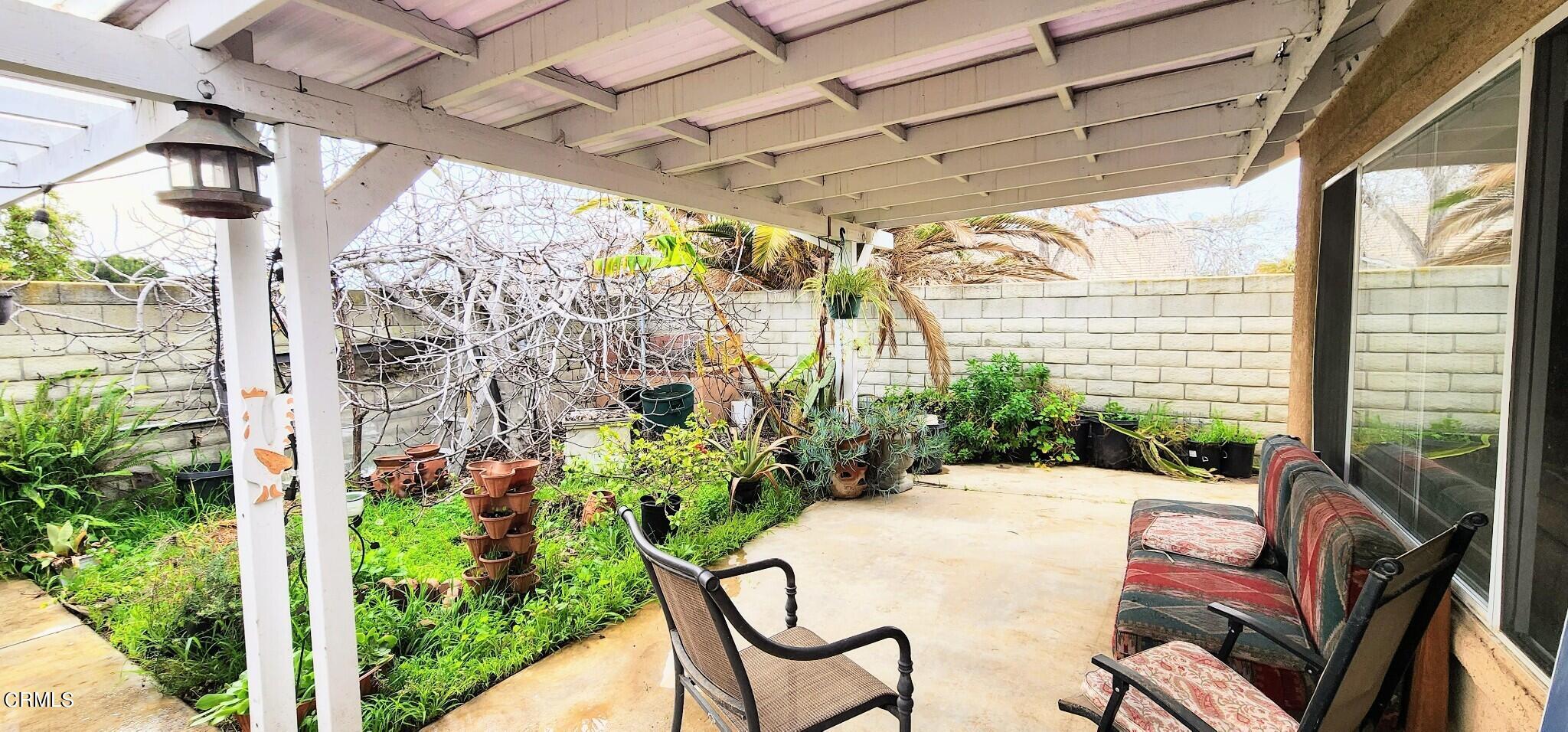 1500 Gabriella Drive Oxnard, CA 93030 - Photo 22 of 23 a view of a patio with table and chairs and potted plants