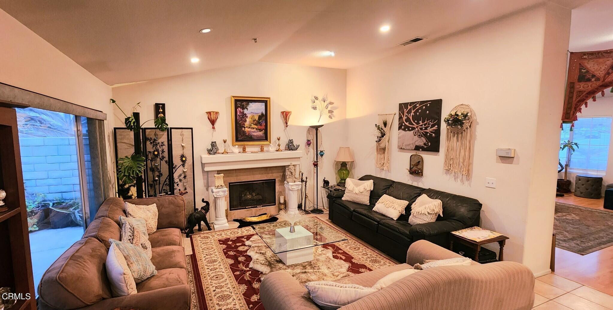 1500 Gabriella Drive Oxnard, CA 93030 - Photo 6 of 23 a living room with furniture a fireplace and a flat screen tv