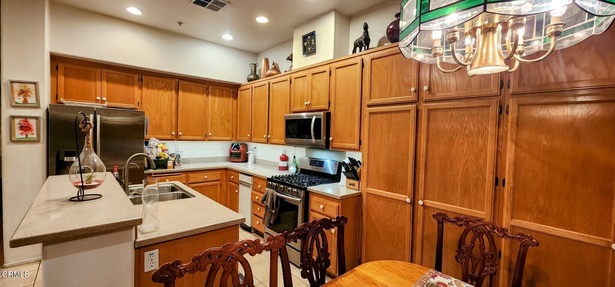1500 Gabriella Drive Oxnard, CA 93030 - Photo 8 of 23 a kitchen with stainless steel appliances a refrigerator stove and microwave