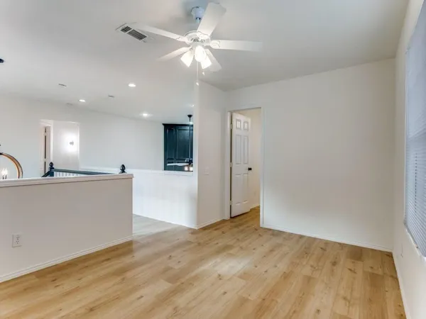 a view of kitchen with kitchen island wooden floor and ceiling fan