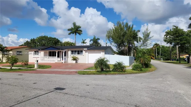 a front view of a house with a yard and outdoor seating