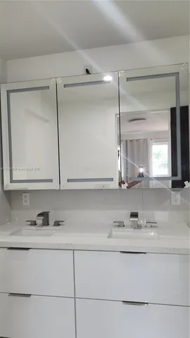 a bathroom with a sink and mirror