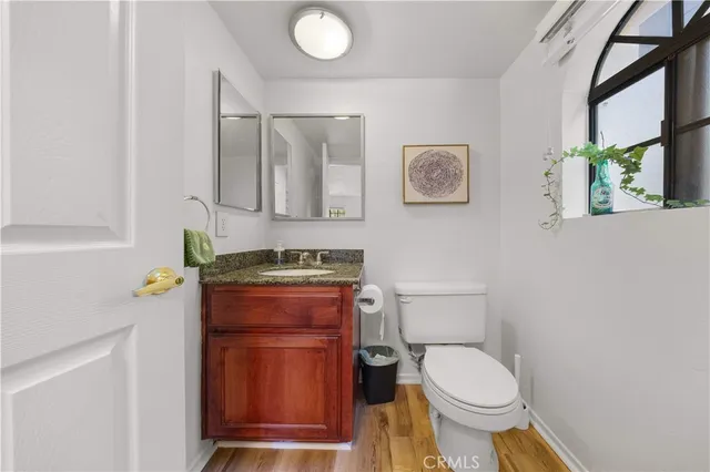 a bathroom with a toilet a sink and mirror