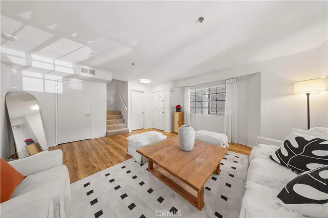 a bedroom with furniture and a wooden floor