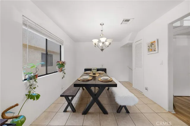 a view of a dining room with furniture and chandelier