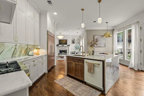 a kitchen with stainless steel appliances granite countertop a sink a stove and a refrigerator