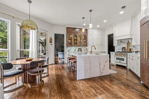 a living room with kitchen island furniture and a chandelier