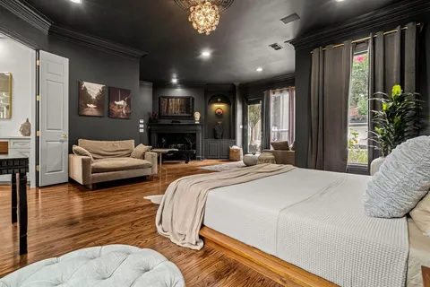 a spacious bedroom with a bed window and couch