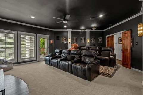 a media room with lots of chairs and a projector screen