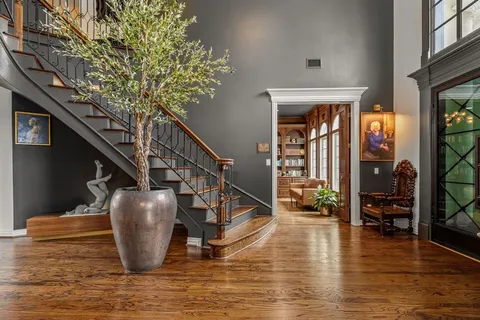 a view of entryway and hall with wooden floor