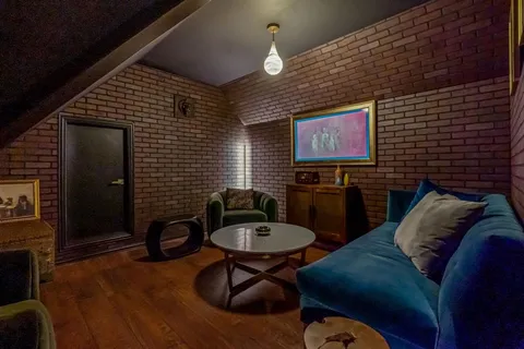 a living room with furniture and a lamp