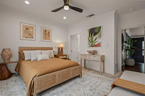 a bedroom with a bed and ceiling fan