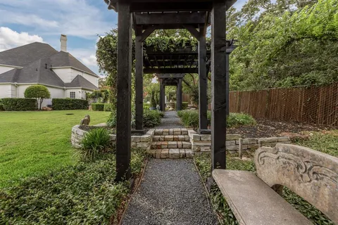 a view of a patio with table and chairs with plants