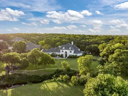 an aerial view of a house with yard swimming pool and outdoor seating