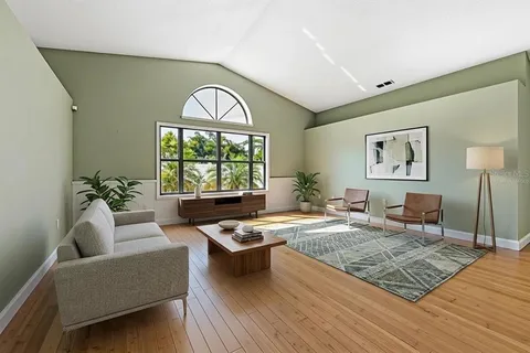 a living room with furniture window and wooden floor