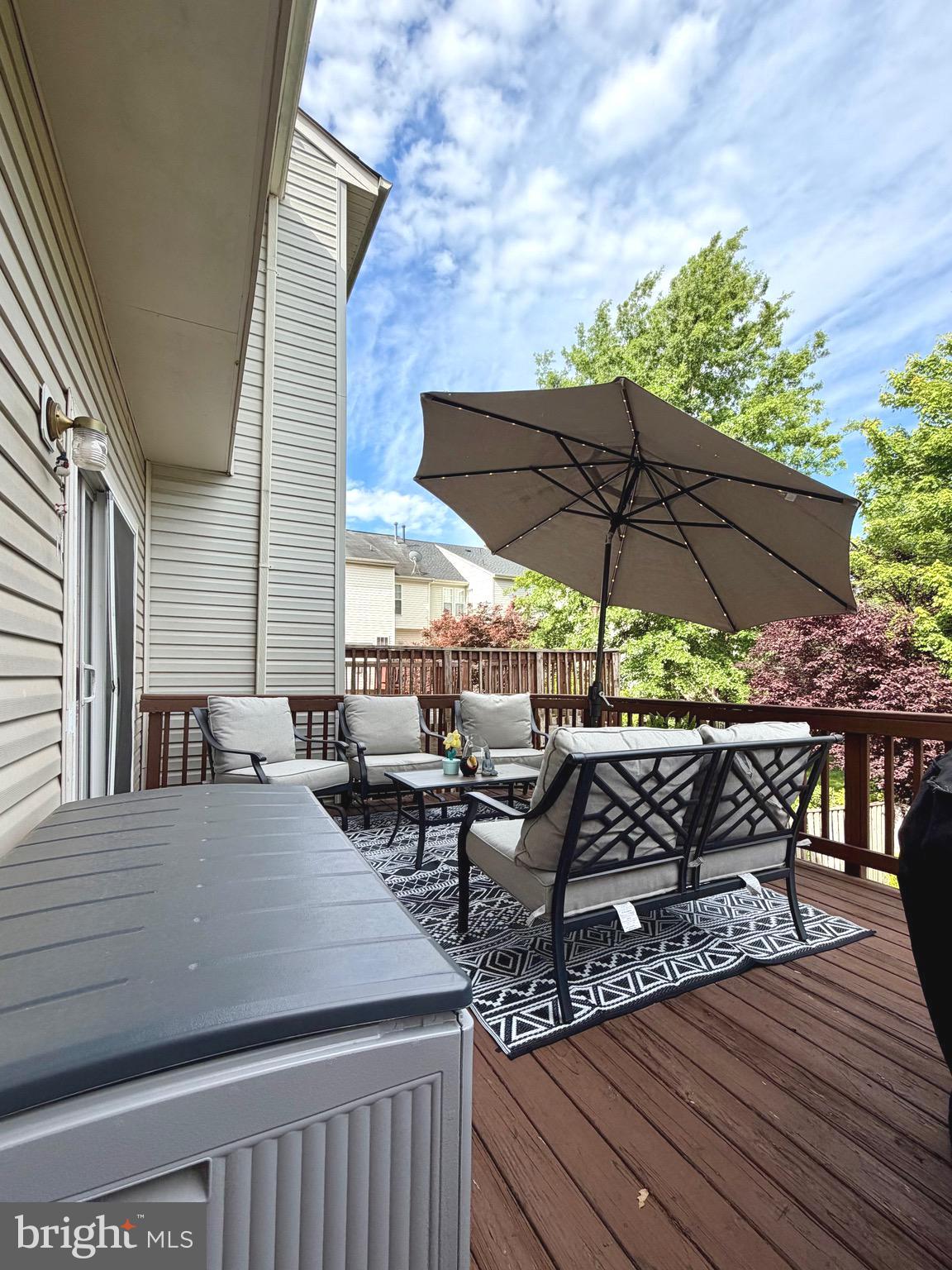 7108 Wheeling Way Gainesville, VA 20155 - Photo 16 of 45 a terrace with outdoor seating and wooden floor