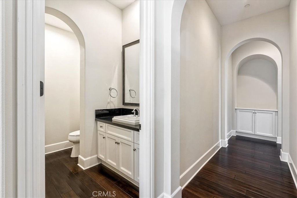 72 Clifford Irvine, CA 92618 - Photo 23 of 65 a bathroom with a granite countertop toilet a sink and a mirror