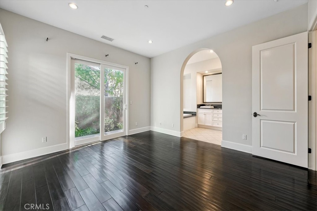 72 Clifford Irvine, CA 92618 - Photo 25 of 65 a view of an empty room with wooden floor and a window