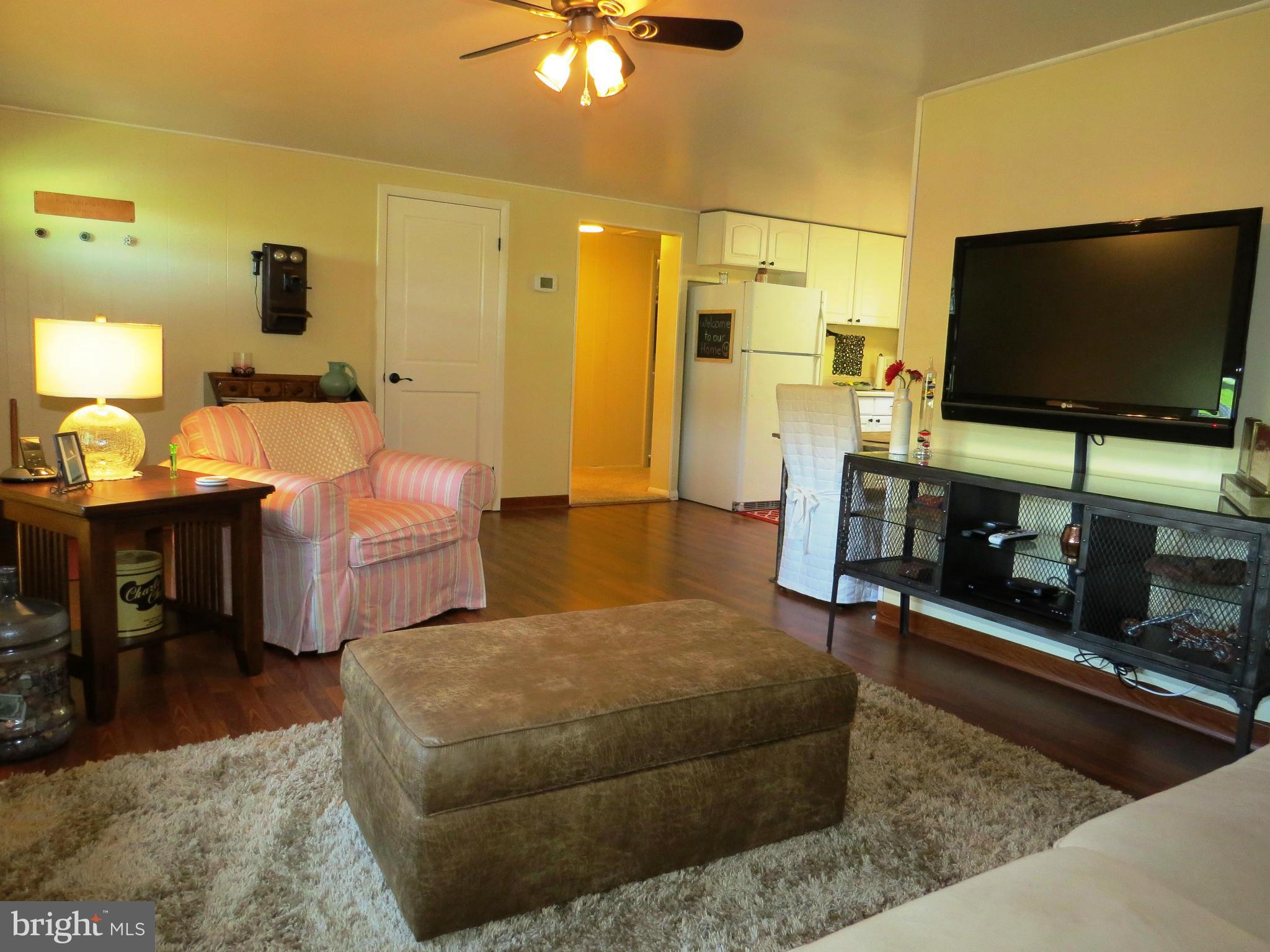 3313 Maple Grove Road Hampstead, MD 21074 - Photo 2 of 30 a living room with furniture and a flat screen tv