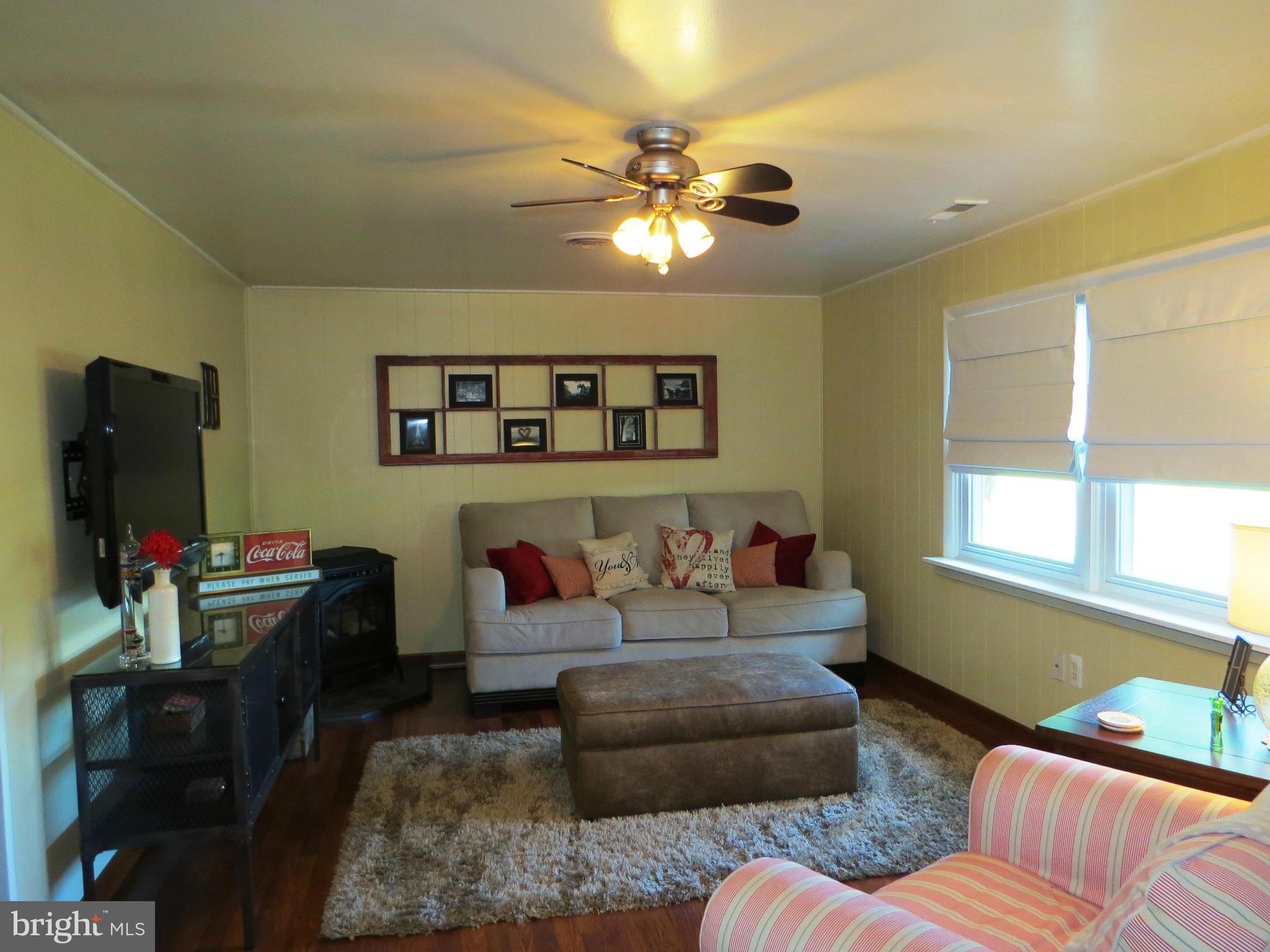 3313 Maple Grove Road Hampstead, MD 21074 - Photo 12 of 30 a living room with furniture and a flat screen tv