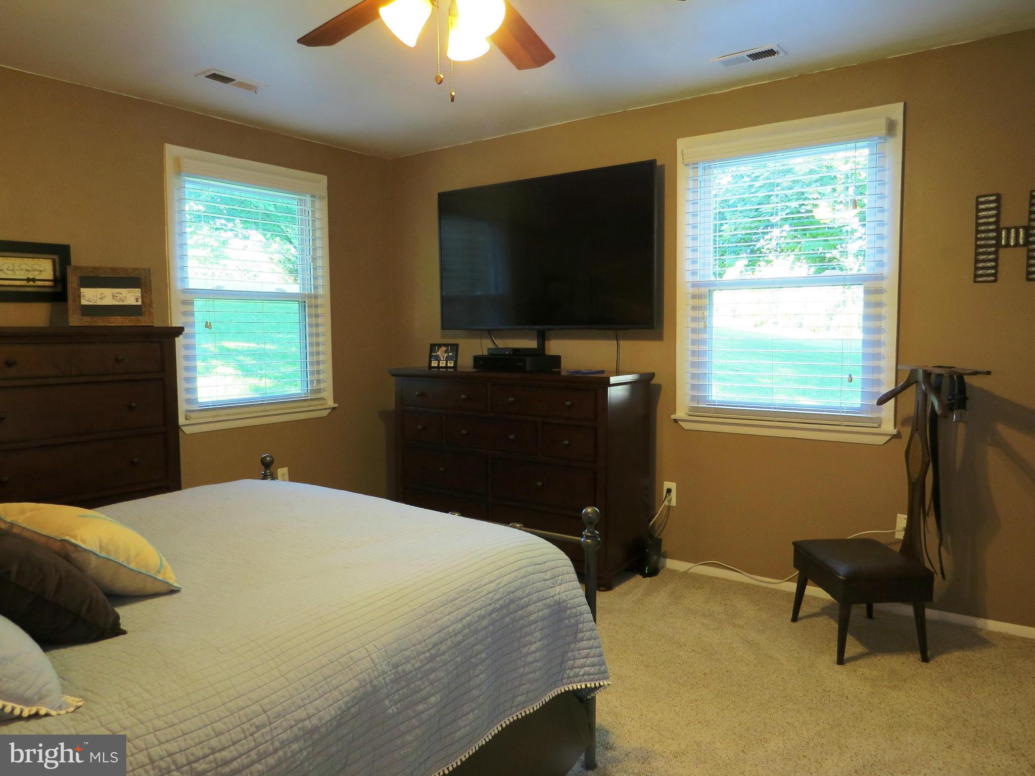 3313 Maple Grove Road Hampstead, MD 21074 - Photo 20 of 30 a bedroom with a bed and a flat tv screen on dresser