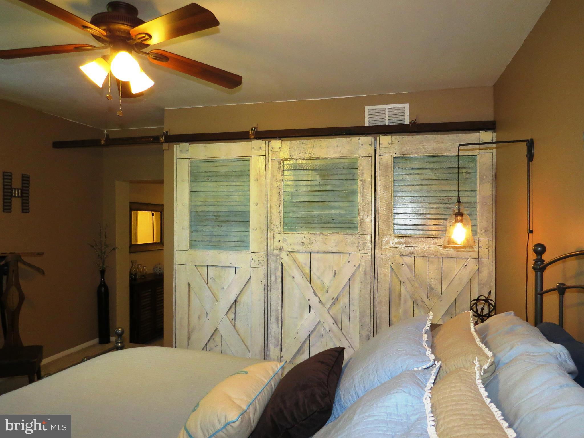 3313 Maple Grove Road Hampstead, MD 21074 - Photo 21 of 30 a living room with a bed furniture and a chandelier